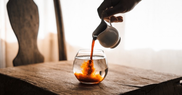 person making an americano coffee