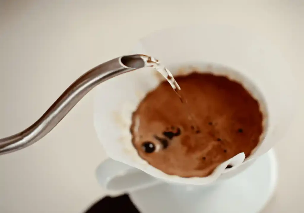 Pouring hot water on a pour over coffee dripper