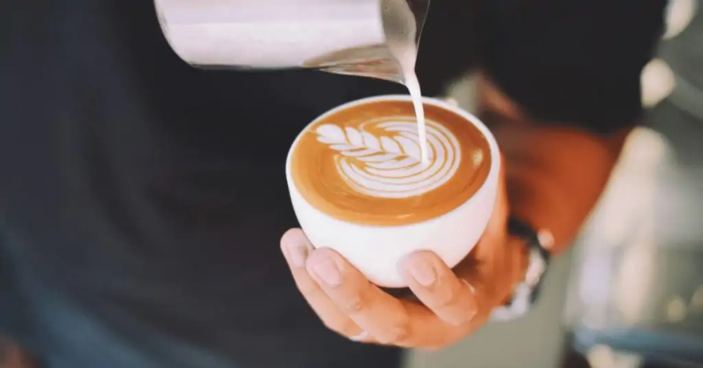 barista making a cappuccino