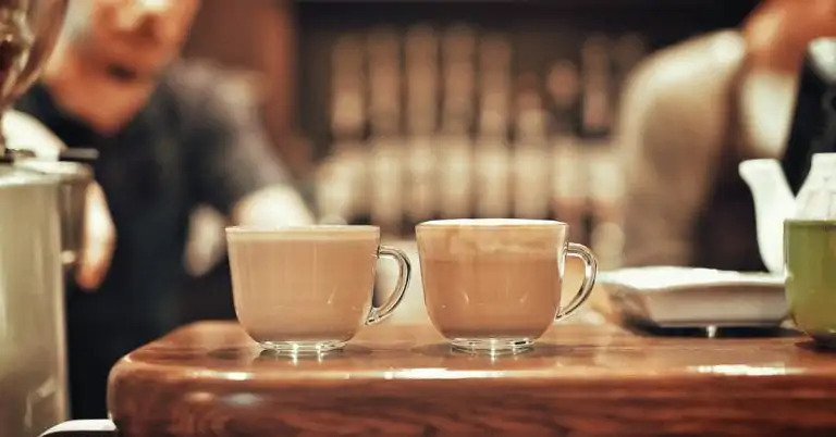 milky coffee drinks in glass cups