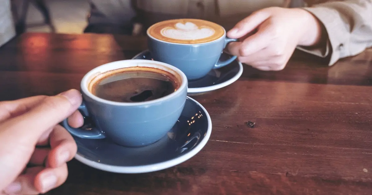 black coffee and a cappuccino in blue cups