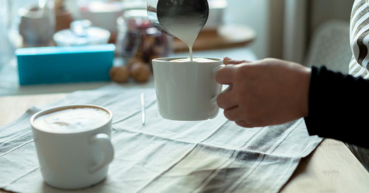 a person preparing latte coffee