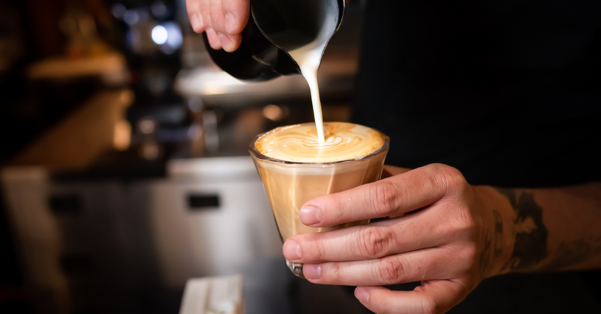 a barista preparing flat white coffee