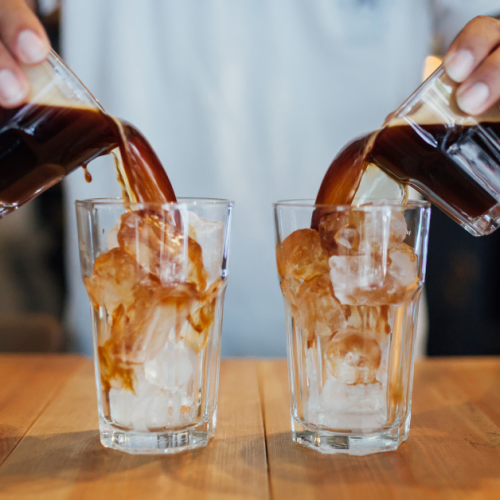 a person preparing iced americano coffee