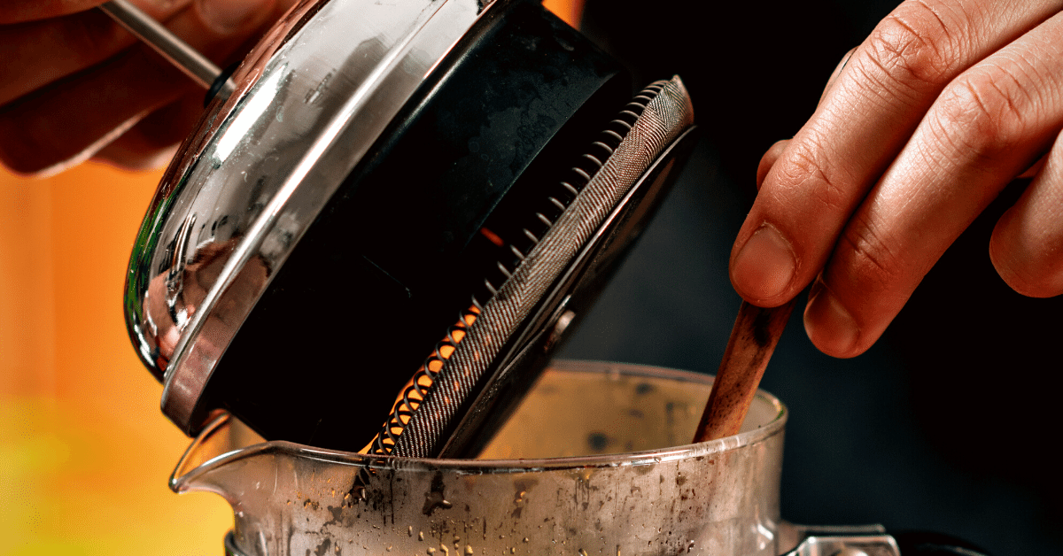 a person making french press coffee