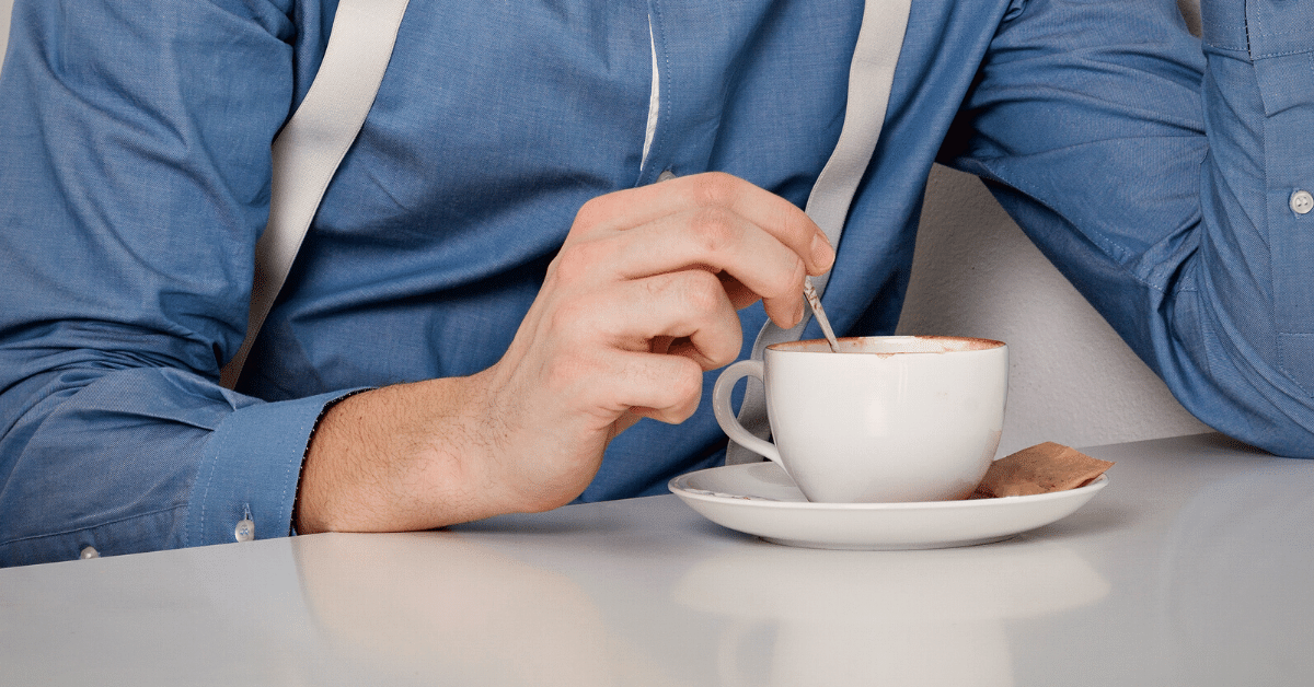 man stirring coffee