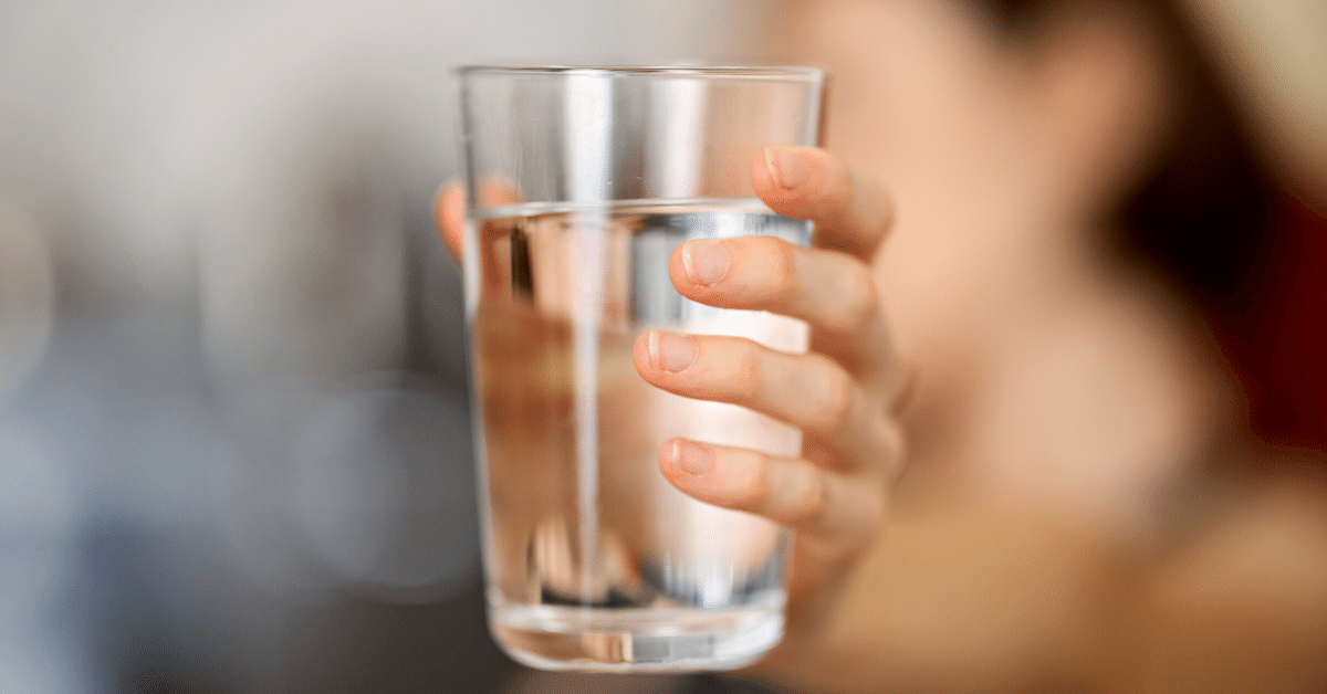 persong holding glass of water