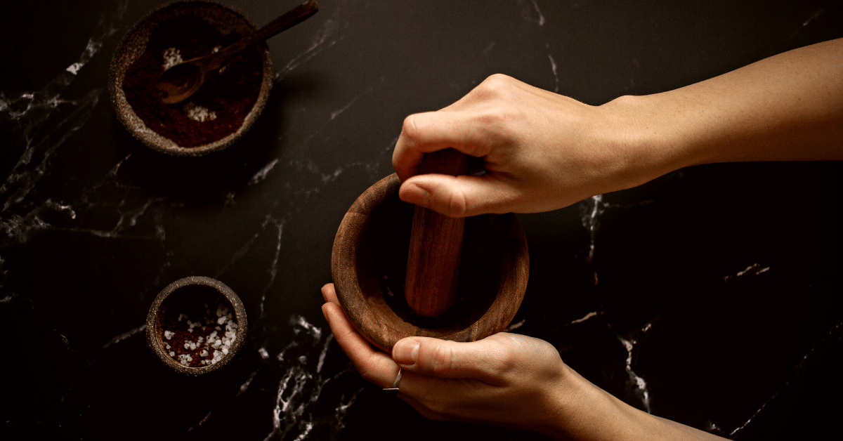 woman grinding coffee in mortar