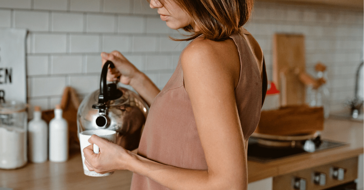 woman pouring coffee in a cup