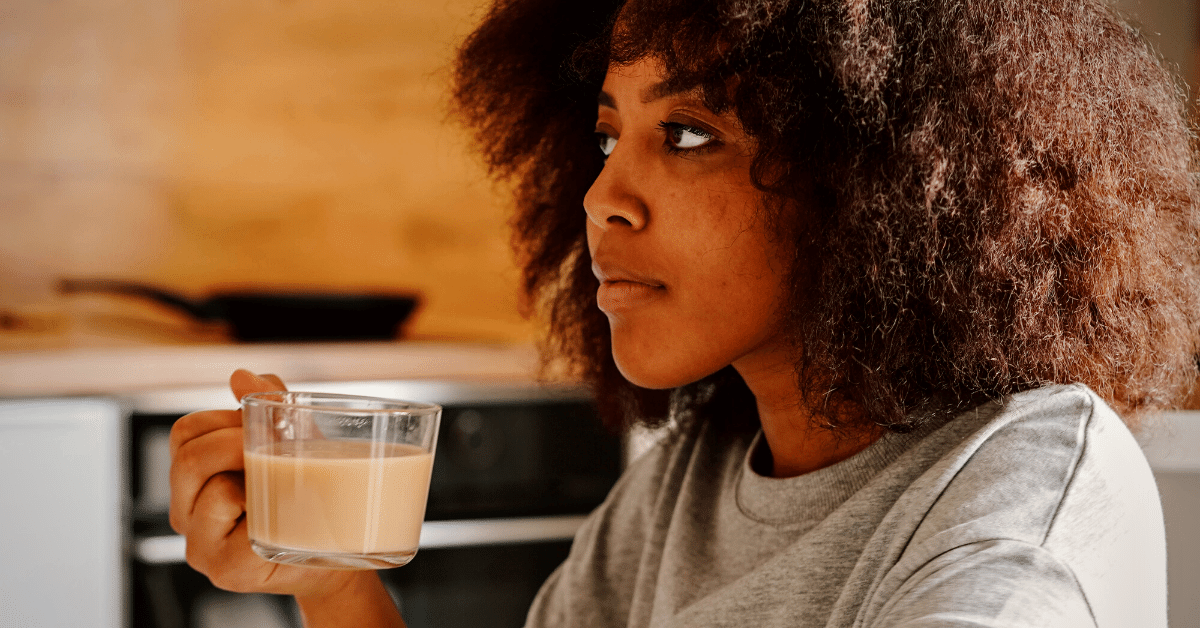 woman holding cup of coffee