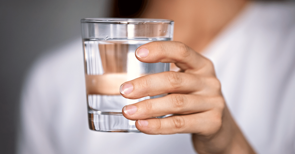 woman holding glass of water