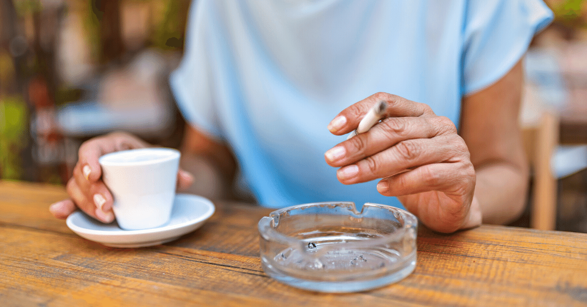 woman smoking cigarette and drinking coffee