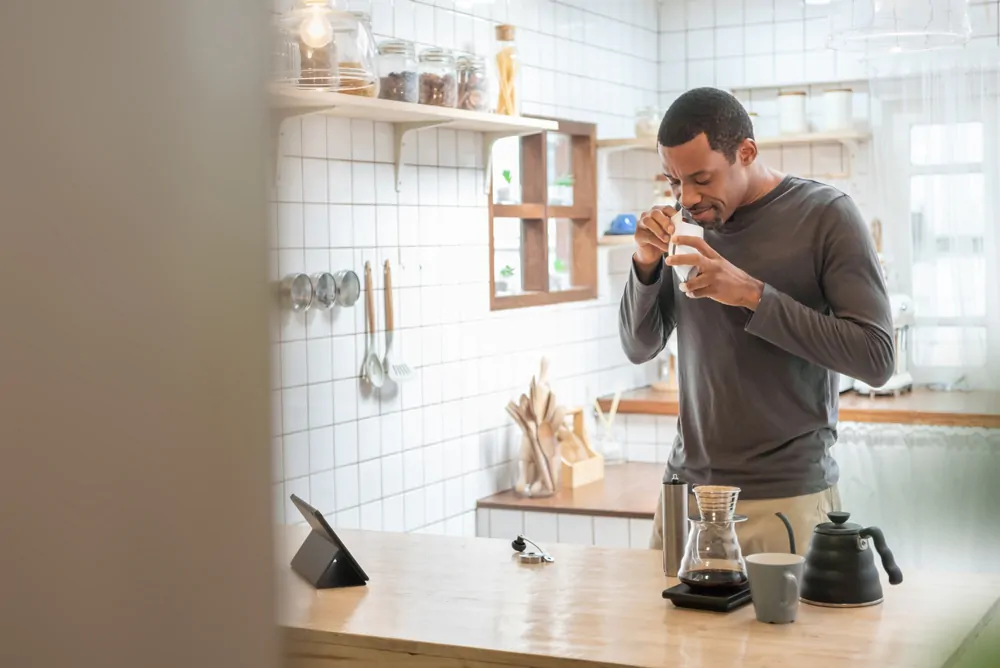 man making coffee drip in kitchen