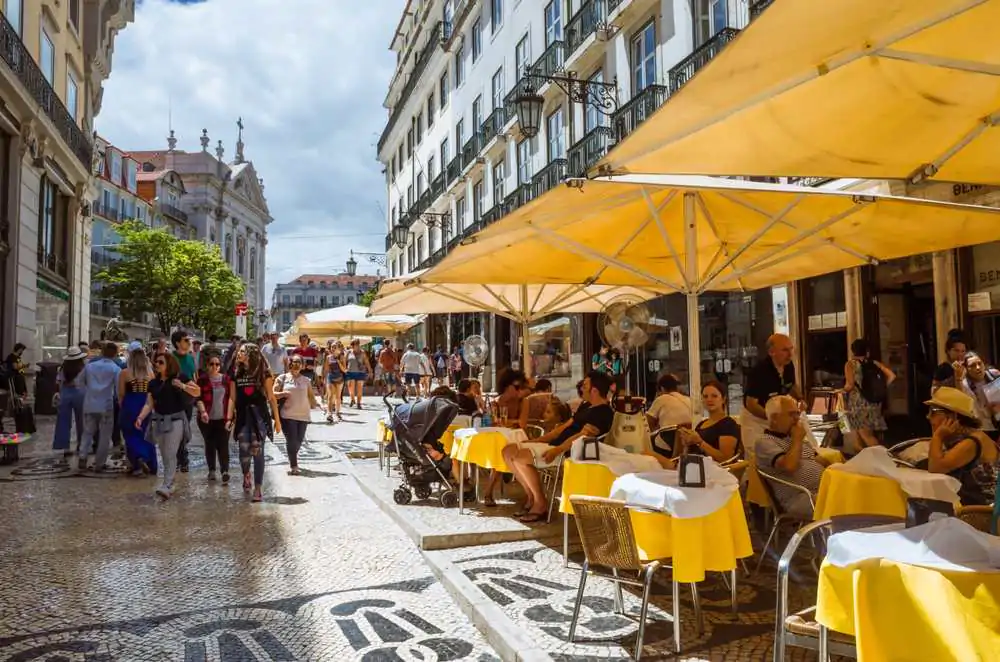 People sit outside Café Pastelaria Bénard, a traditional Pastry-Shop first opened in 1868 in the Chiado district of Lisbon. What is Portuguese coffee?